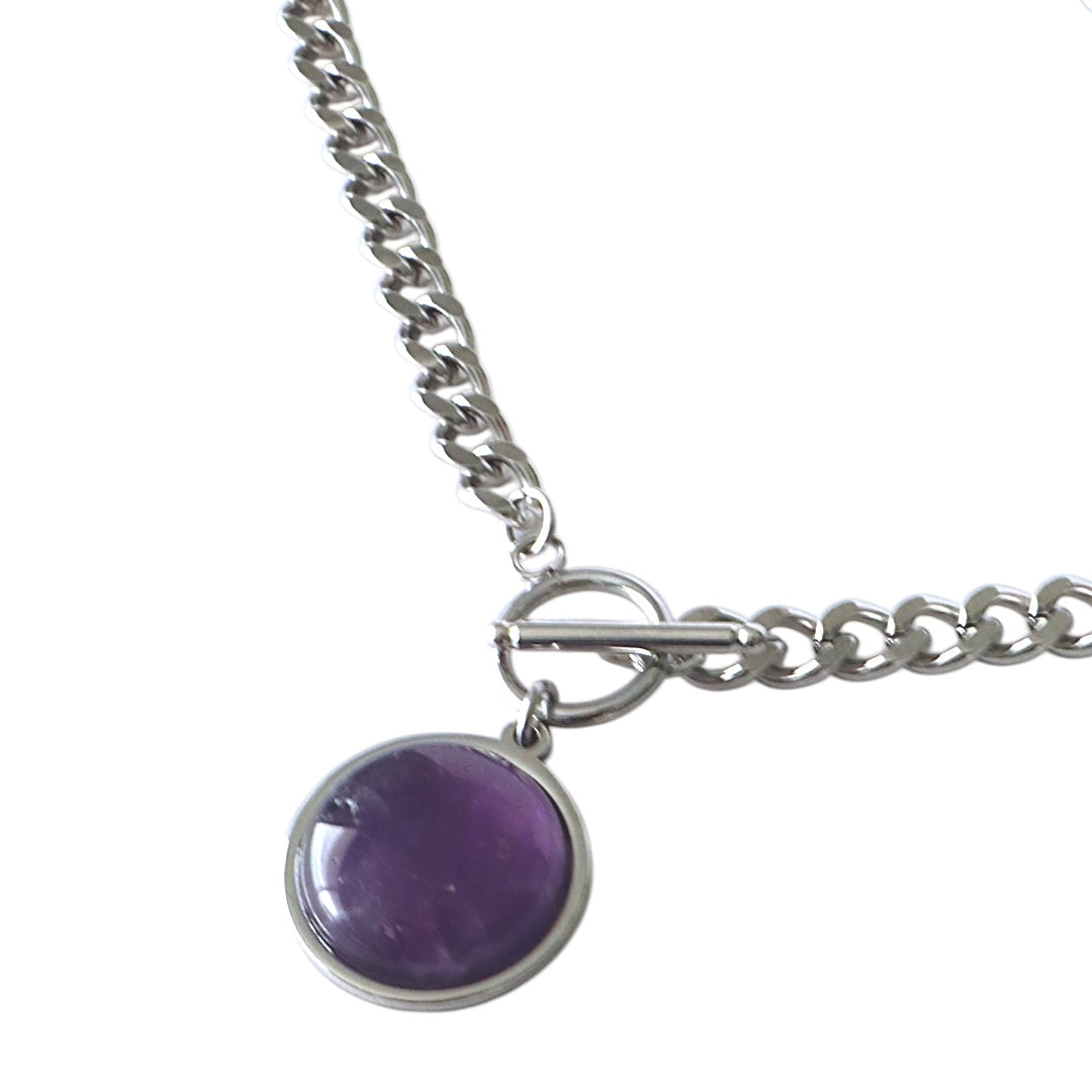 Silver chain necklace with a purple pendant on a white background