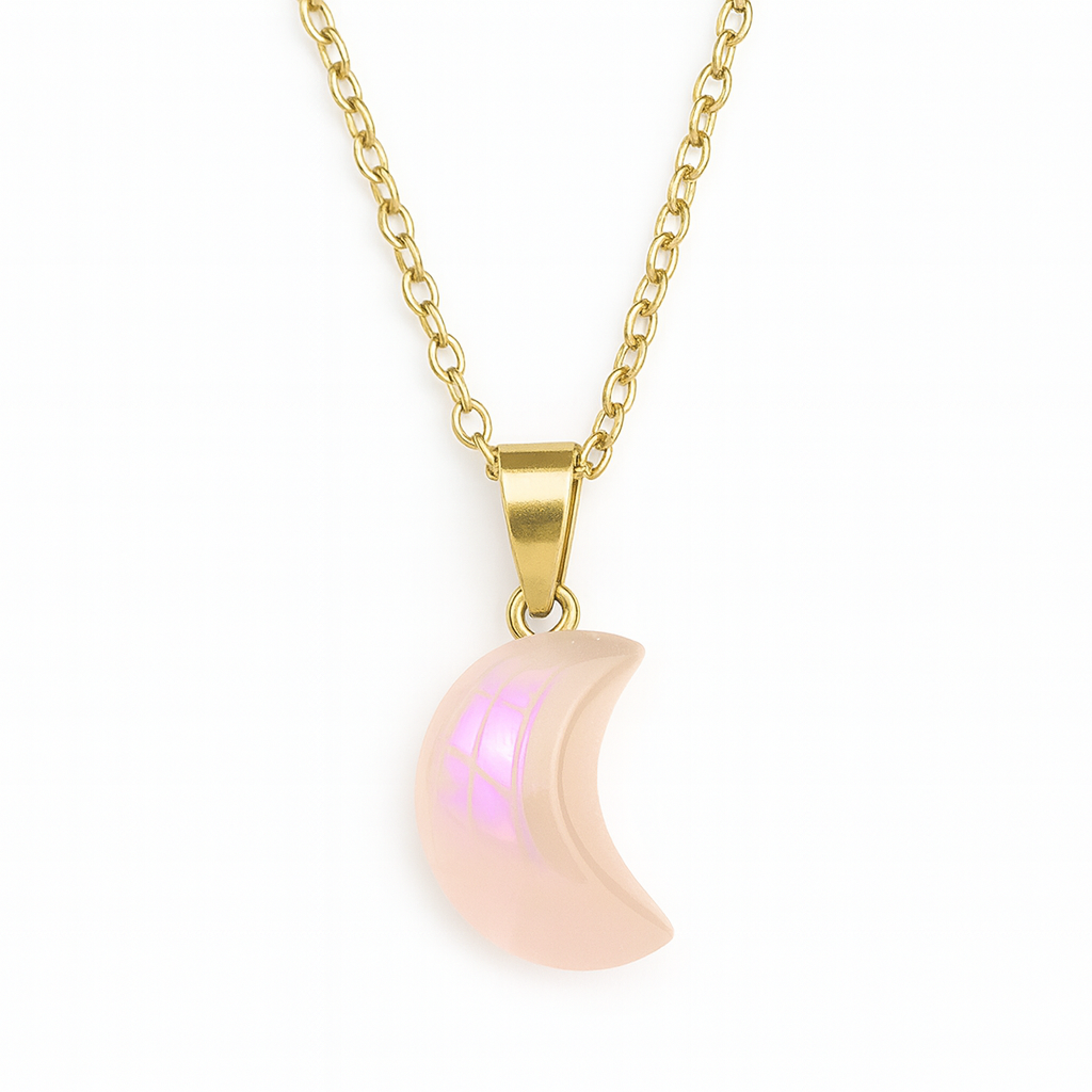 Gold necklace with a pink crescent moon pendant on a white background
