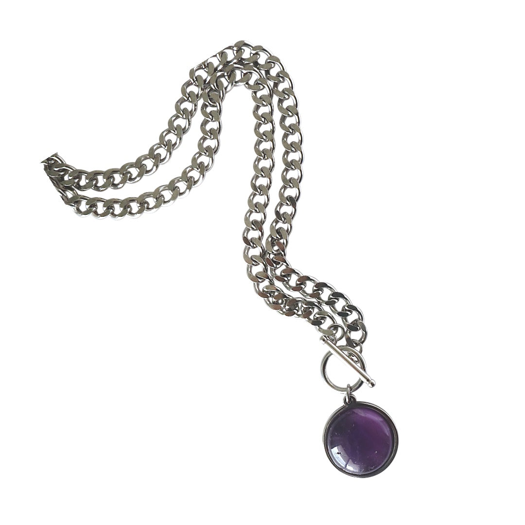 Silver chain necklace with a purple pendant on a white background