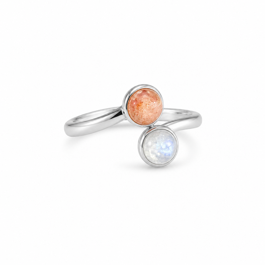 Two silver rings with round gemstones on a white background