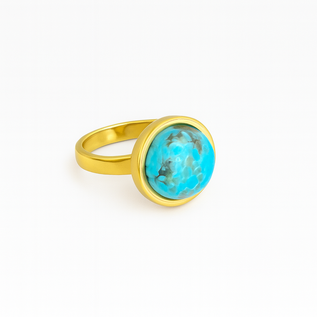 Gold ring with a turquoise stone on a white background