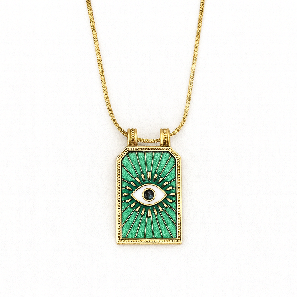 Gold necklace with a green pendant featuring an eye design on a white background