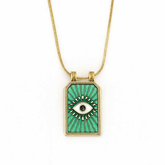 Gold necklace with a green pendant featuring an eye design on a white background