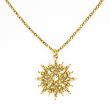 Gold star-shaped pendant necklace on a white background