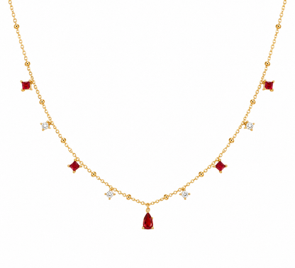Gold necklace with red gemstones on a white background