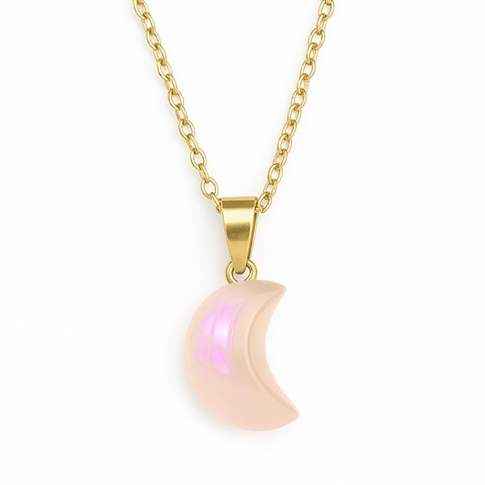 Gold necklace with a pink crescent moon pendant on a white background
