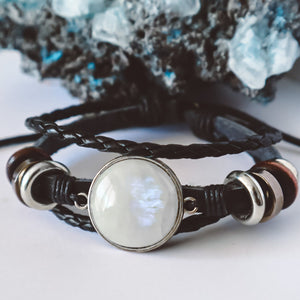"Boho-inspired Rainbow Moonstone Beaded Stack Bracelet featuring a 20mm AAA-grade moonstone on an adjustable braided bracelet with beads and faux leather."
