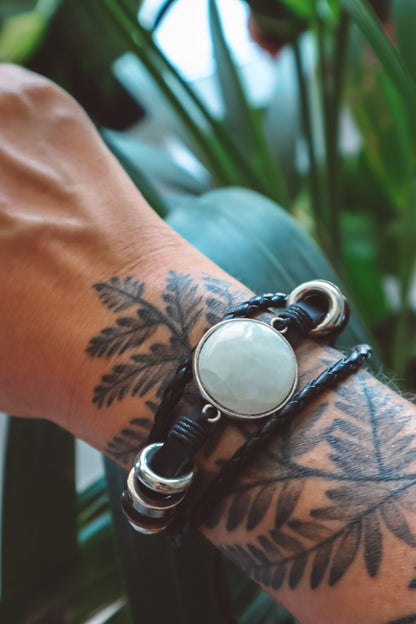 "Boho-inspired Rainbow Moonstone Beaded Stack Bracelet featuring a 20mm AAA-grade moonstone on an adjustable braided bracelet with beads and faux leather."