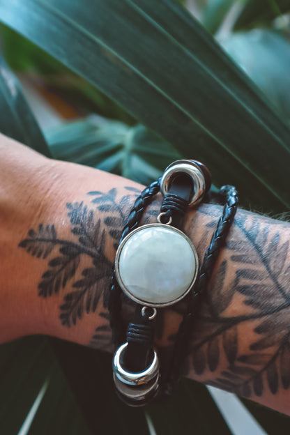 "Boho-inspired Rainbow Moonstone Beaded Stack Bracelet featuring a 20mm AAA-grade moonstone on an adjustable braided bracelet with beads and faux leather."