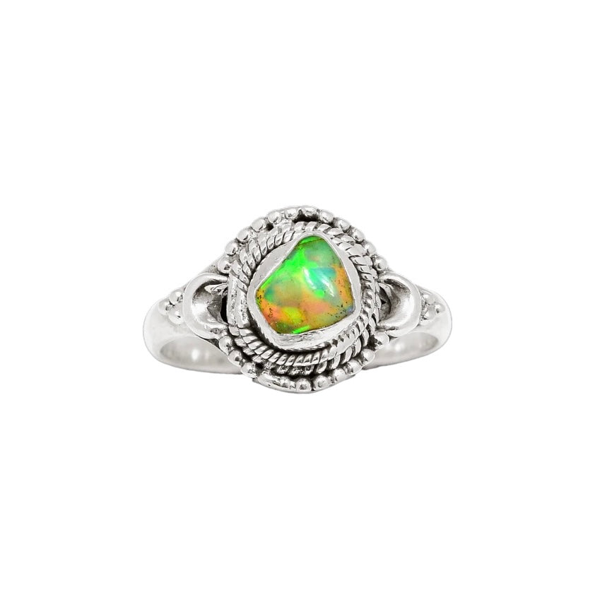 Silver ring with a heart-shaped opal stone on a white background