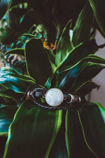 Lade das Bild in den Galerie-Viewer, &quot;Boho-inspired Rainbow Moonstone Beaded Stack Bracelet featuring a 20mm AAA-grade moonstone on an adjustable braided bracelet with beads and faux leather.&quot;
